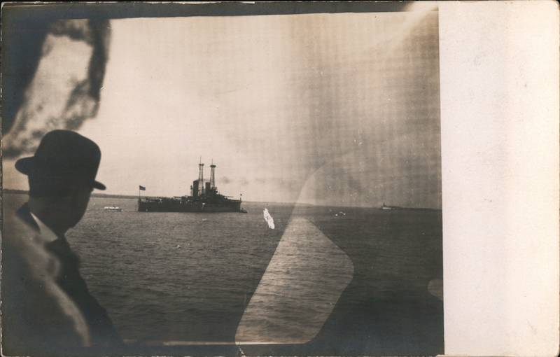 Man Looking at a Military Ship on The Water Navy