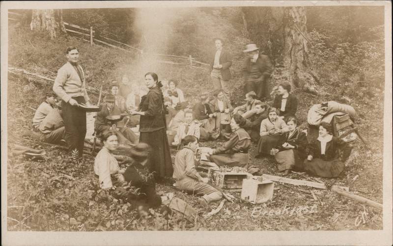 People Cooking and Eating Around a Campfire C.H. Camping