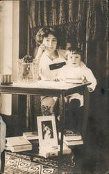 Woman and Child at Table with Books Postcard