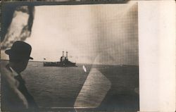 Man Looking at a Military Ship on The Water Postcard