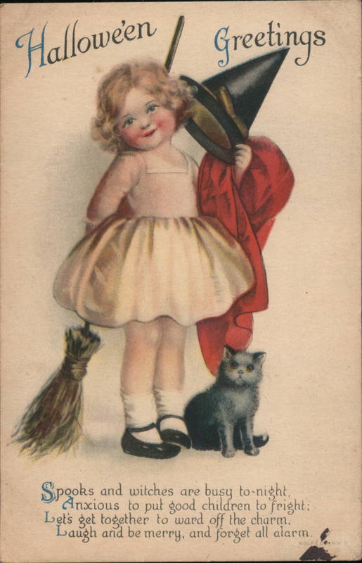 Young Girl Holding a Witch's Costume with Black Cat