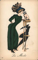 "The Fashion" - Cartoonish Drawing of Woman in Green Pantsuit, Blue Hat and Large Bow Leaning Towards Dog on Table Top Artist Si Postcard