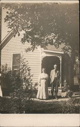 Older Couple Outside Home Postcard