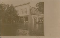 A flooded street view of businesses Postcard