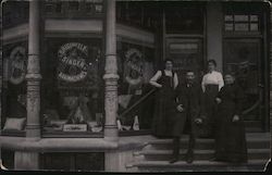Employees in front of Singer sewing machines store Postcard
