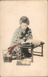 Japanese woman reading a book Postcard