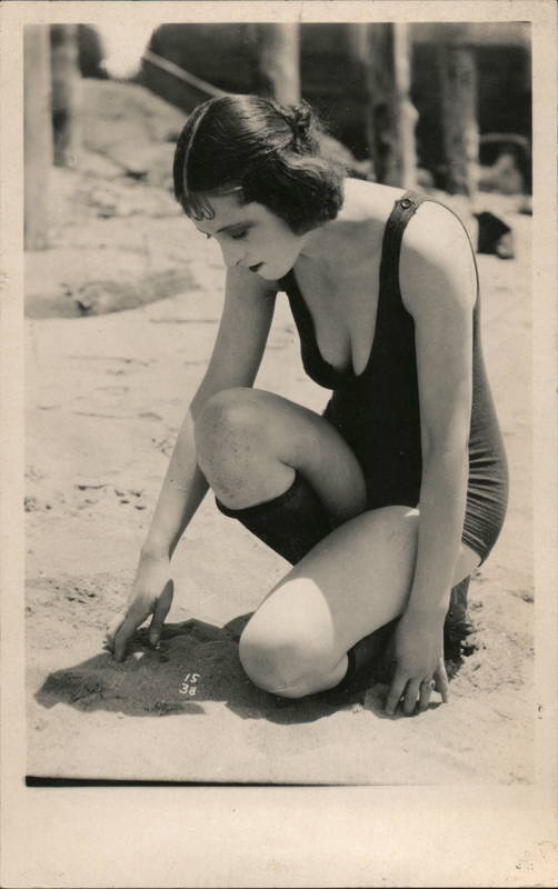 Flapper Woman in Bathing Suit Kneeling in Sand 1920s