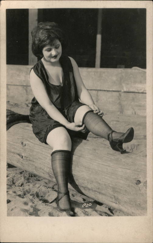 Flapper Woman on Beach Rolling Stockings Below Knees