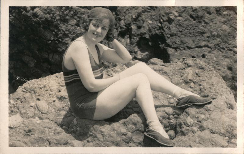 Flapper Woman in Bathing Suit Sitting on Rocks 1920s