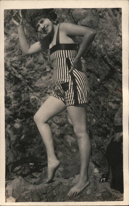 Flapper Woman in Striped Short Overalls Posing by Rocks