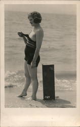 Flapper Woman on a beach removing her bathing suit Postcard