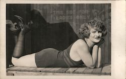 Lady lies on bench Postcard