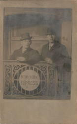 Two men in hats stand in front of "New York Express" sign Postcard