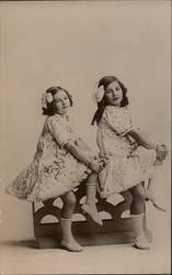 Two young girls pose Postcard