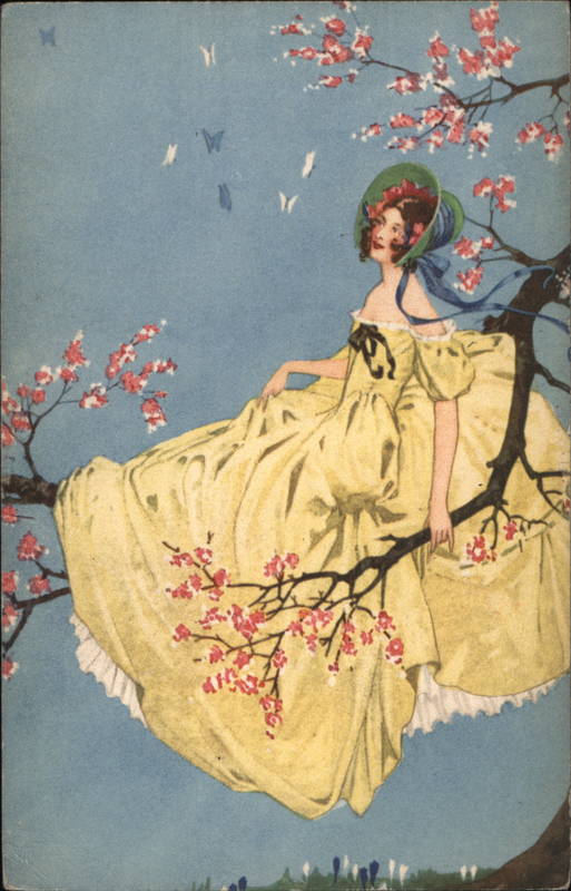 Woman in large flowing yellow dress sits on tree branch