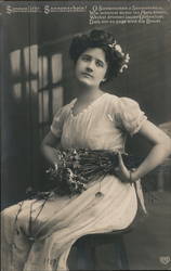 German Women sitting with flowers in hand Postcard