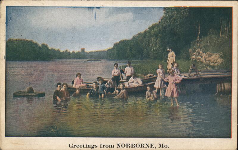 Family posing in a lake and boat Norborne Missouri