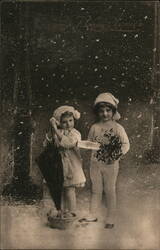 Two Children with Umbrella, Basket, and Holly in Snow, Bonne Année Postcard