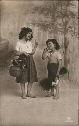 Two Barefoot Children with Flowers and Puppies Postcard