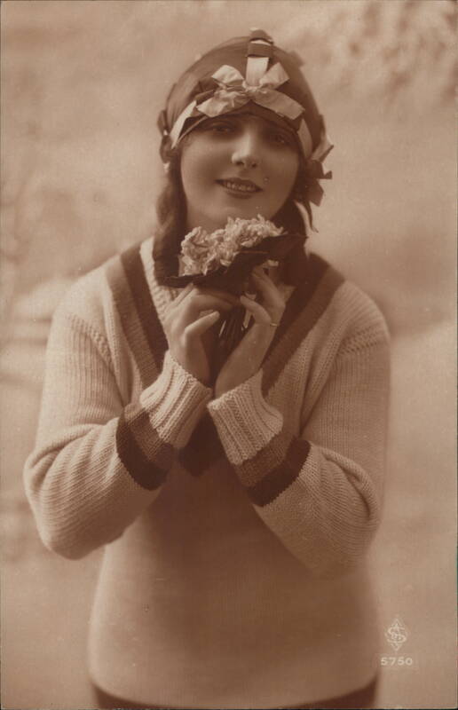 Young Woman in Knit Sweater with Headscarf Holding Flowers