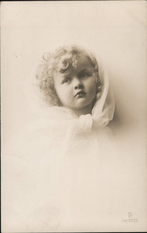 Portrait of a Young Child with Curly Hair and a White Veil