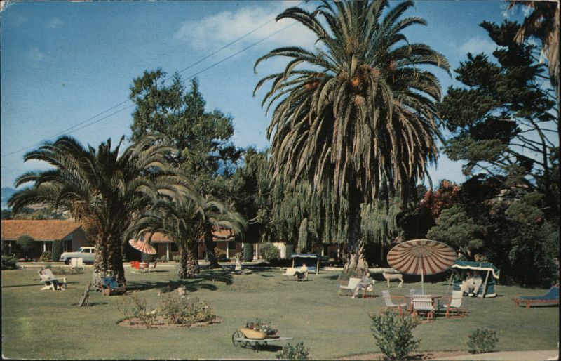 Ranchotel Motel, Lush Grounds with Palm Trees and Guests Relaxing San Luis Obispo California