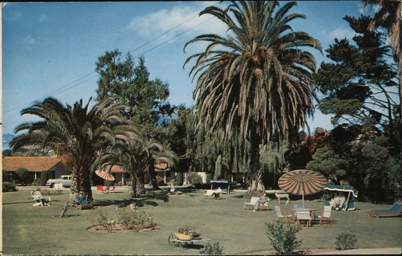 Ranchotel Motel, Lush Grounds with Palm Trees and Guests Relaxing San Luis Obispo California