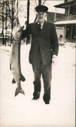 Man Standing in the Snow with Muskie Postcard