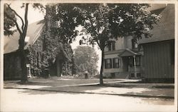 Street View of Man Standing Near Ivy Covered Front of Building Postcard