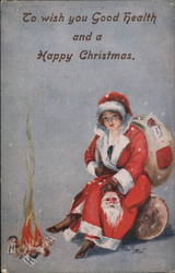 A Female Santa Claus sits by a fire Arthur Butcher Postcard Postcard Postcard