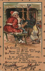 Santa Claus Sitting in Front of Fireplace Sorting Gifts for Stockings Postcard