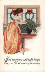 Woman strightening Christmas Plant on a table Postcard Postcard Postcard