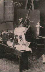 Girl Teaching Dolls in 'School of Art' Postcard