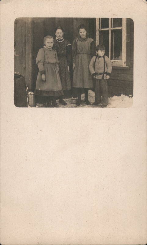 Children and Woman Outside Wooden Building in Winter