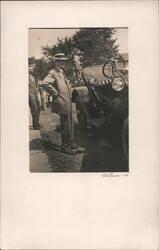 Man in Suit and Hat Posing by Early Automobile Postcard