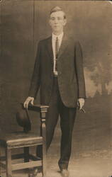 Young Man in Suit Holding Hat and Cigar Postcard