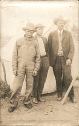 Three Men Posing Outdoors by Tent Postcard
