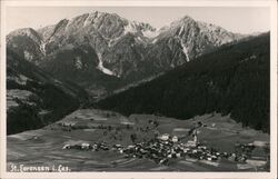 St. Lorenzen i. Les. aerial view of village and mountains Postcard