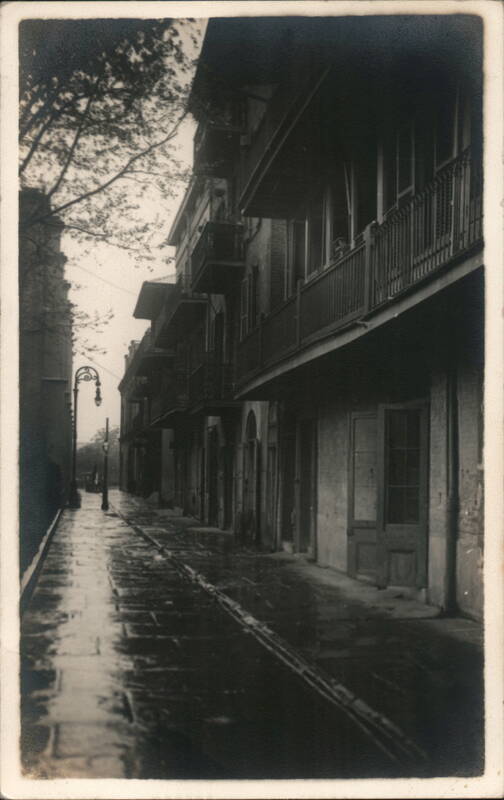 French Quarter, Wet Street with Balconies, Lamppost, and Tracks New Orleans Louisiana