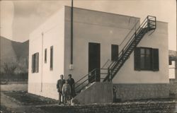 Three People on Stairs of Building with Stone Foundation Postcard