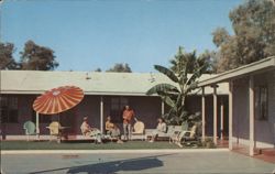 Guests relaxing on the patio at Holiday Inn Postcard