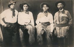 Four Cowboys Posing with Pistols and Chaps Postcard