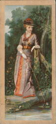 Woman in hat and long dress fishing by a stream, Moore & Murphy Fine Shoes Trade Card