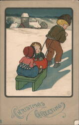 Boy pulling children on sled, Christmas Greetings, snowy village Postcard