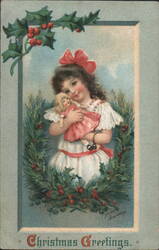 Young Girl with Doll in Holly Wreath, Christmas Greetings by Ellen Clapsaddle Postcard