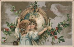 A Merry Christmas Girls Kissing with Holly and Candles Postcard