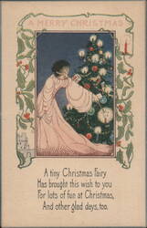A Merry Christmas Fairy Decorating Tree with Candles and Ornaments Postcard