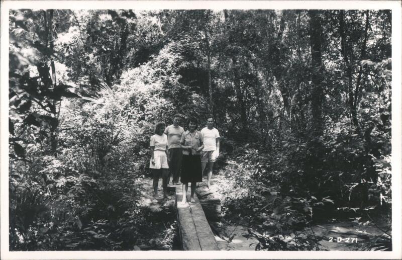 Four People on a Wooden Plank Bridge in Woods Keystone Heights Florida