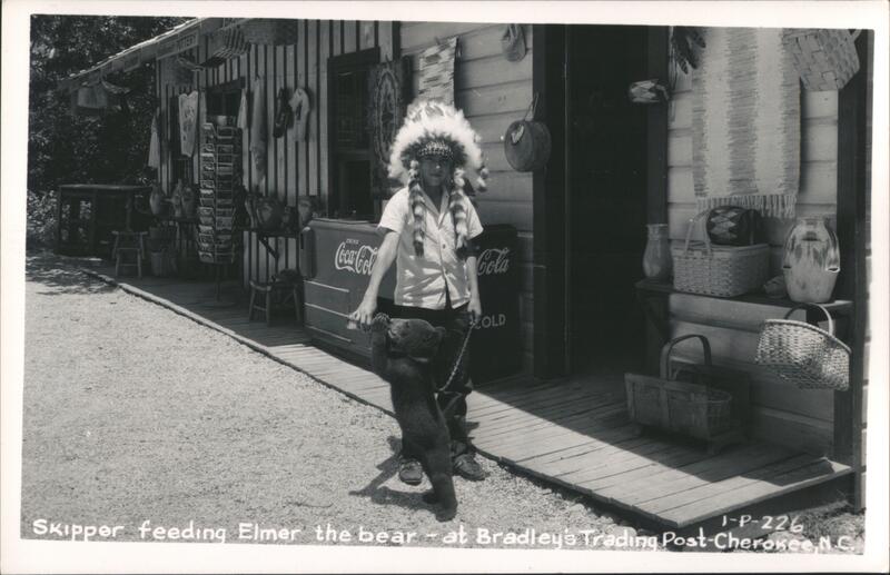 Boy in Native American Headdress Feeding Bear Cub a Coke Cherokee North Carolina
