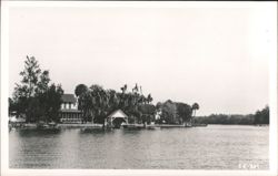 Riverfront Homes with Boat House and Lush Trees Postcard